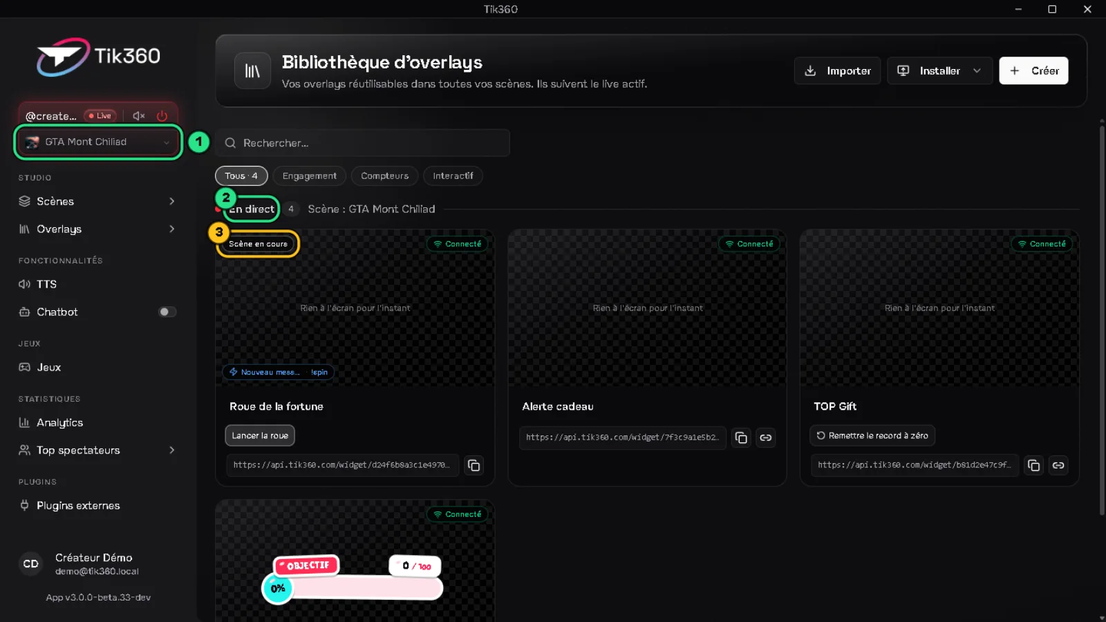 Bibliothèque pendant un live : la scène GTA Mont Chiliad choisie dans le contrôle Live est entourée en vert (1), le titre « En direct » est entouré en vert (2), le badge « Scène en cours » de la roue est entouré (3).